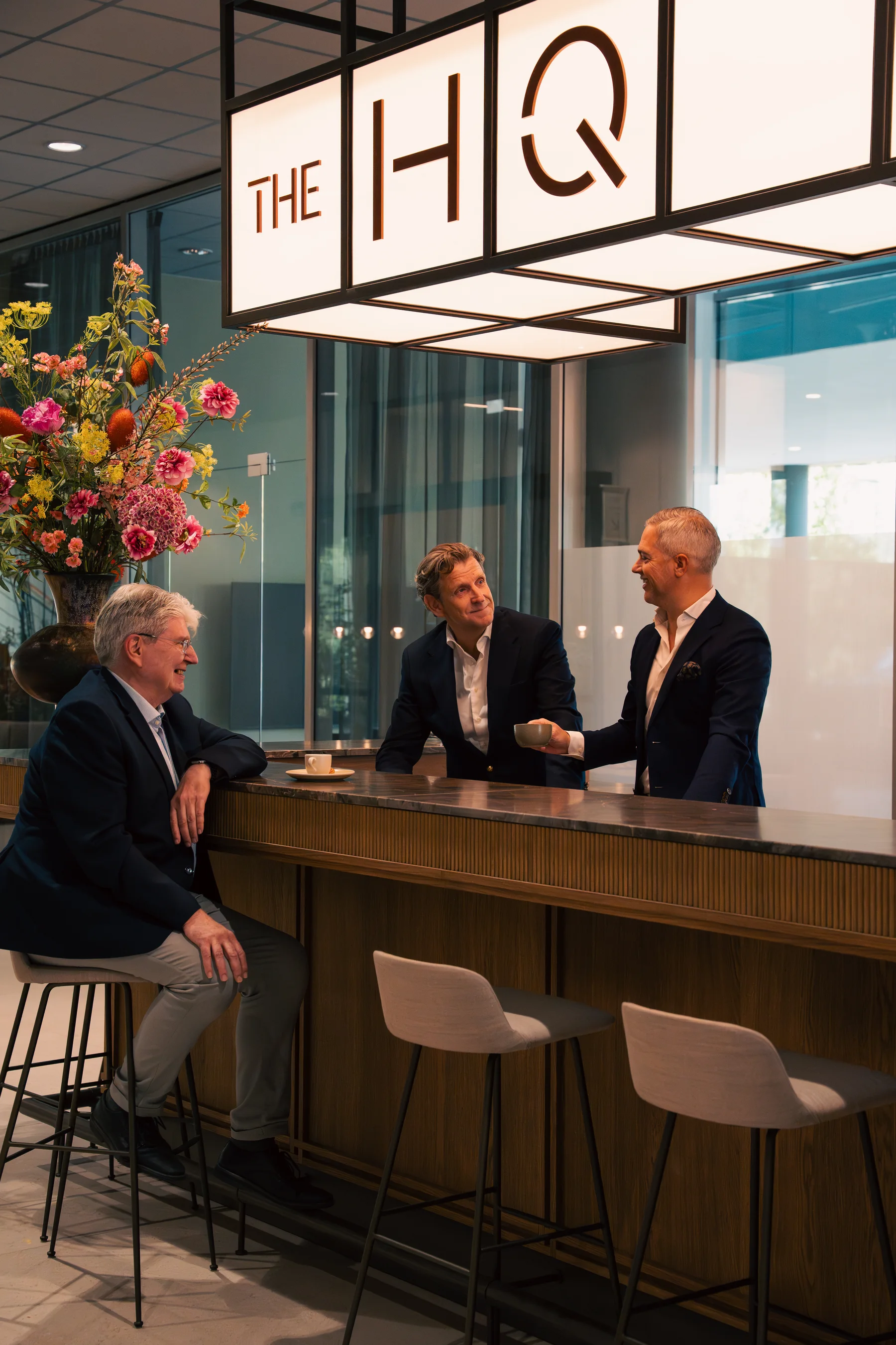 De partners van Valkering & Co. aan de bar op kantoor